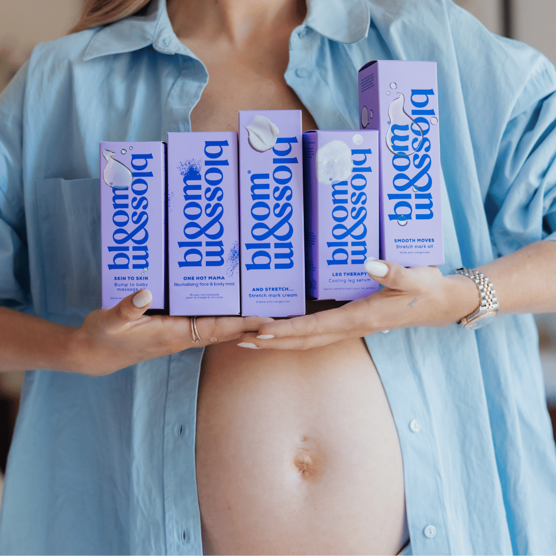 Image of a pregnant woman holding the bloom & blossom pregnancy product range