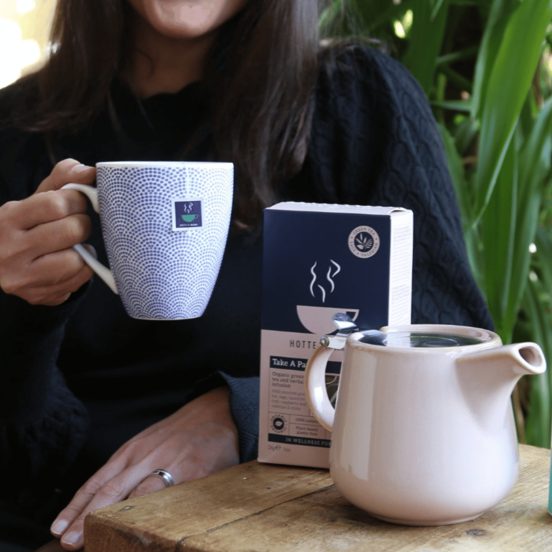 Image of a woman sat drinking HotTea Mama Take a Pause Menopause tea blend