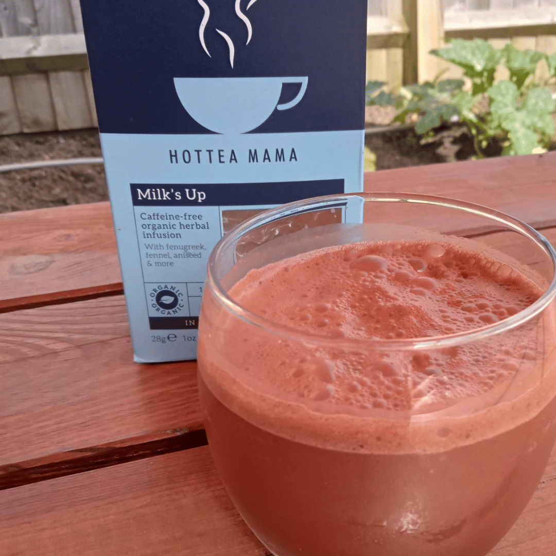 Image of a box of Milk's Up Tea with a glass of Milk's Up Chocolate Milkshake on a wooden garden table