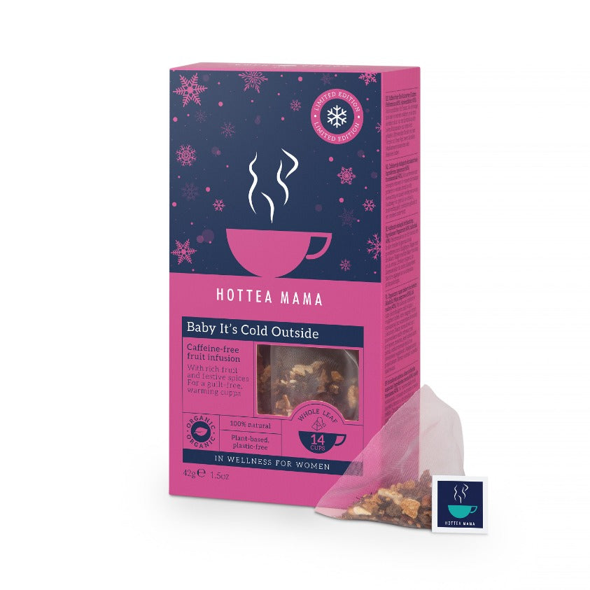 A pack of HotTea Mama Baby Its Cold Outside Christmas tea with snowflakes on the pack and a whole leaf fruit tea bag at its side.