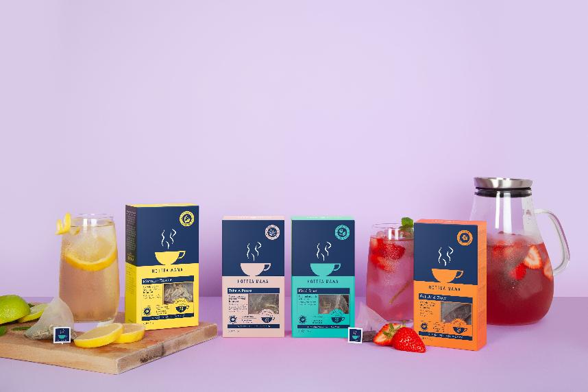 4 boxes of HotTea Mama herbal teas for pregnancy, breastfeeding, sleep support and menopause, say along side iced tea in a jug and glasses