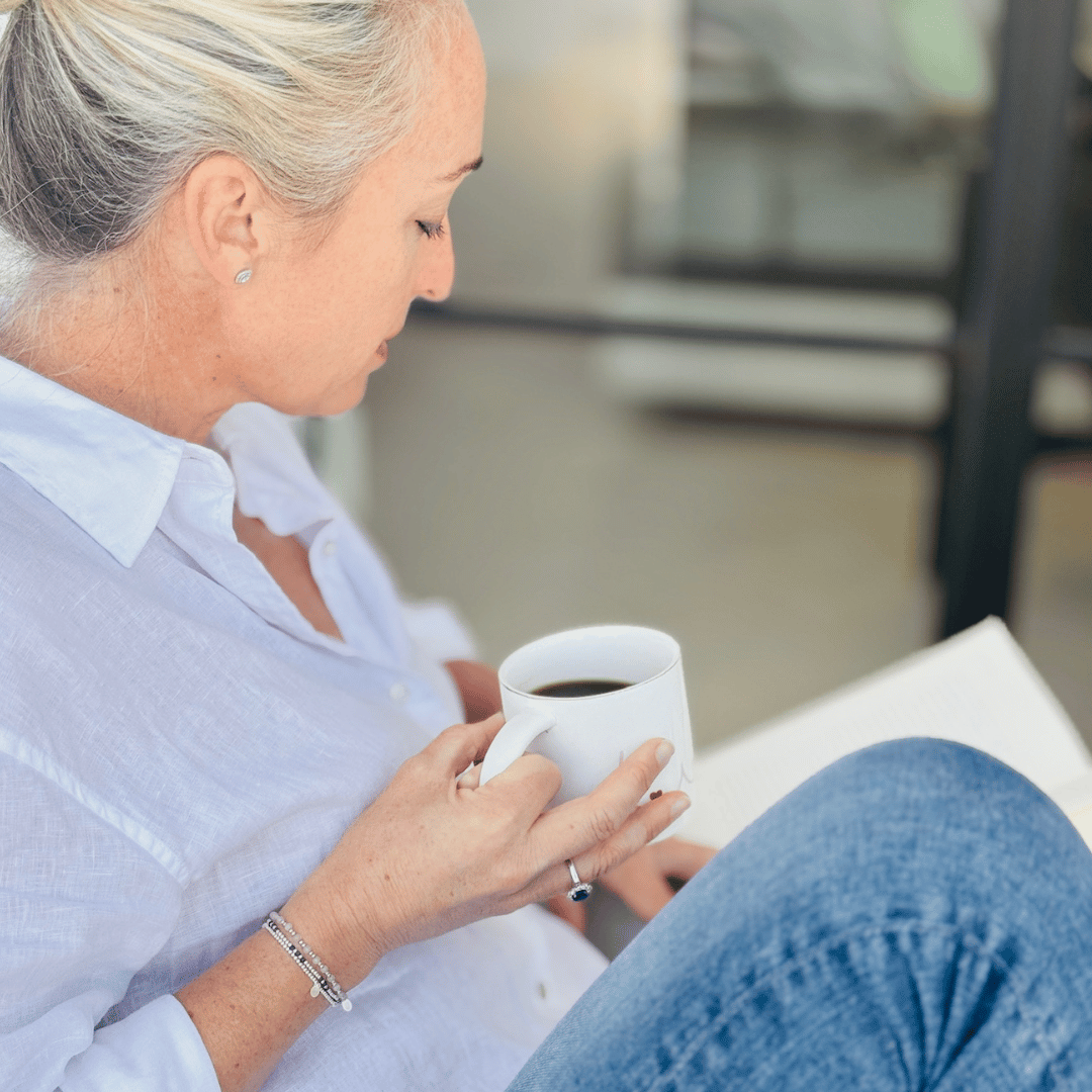 Woman holding a white mug with a blurred background