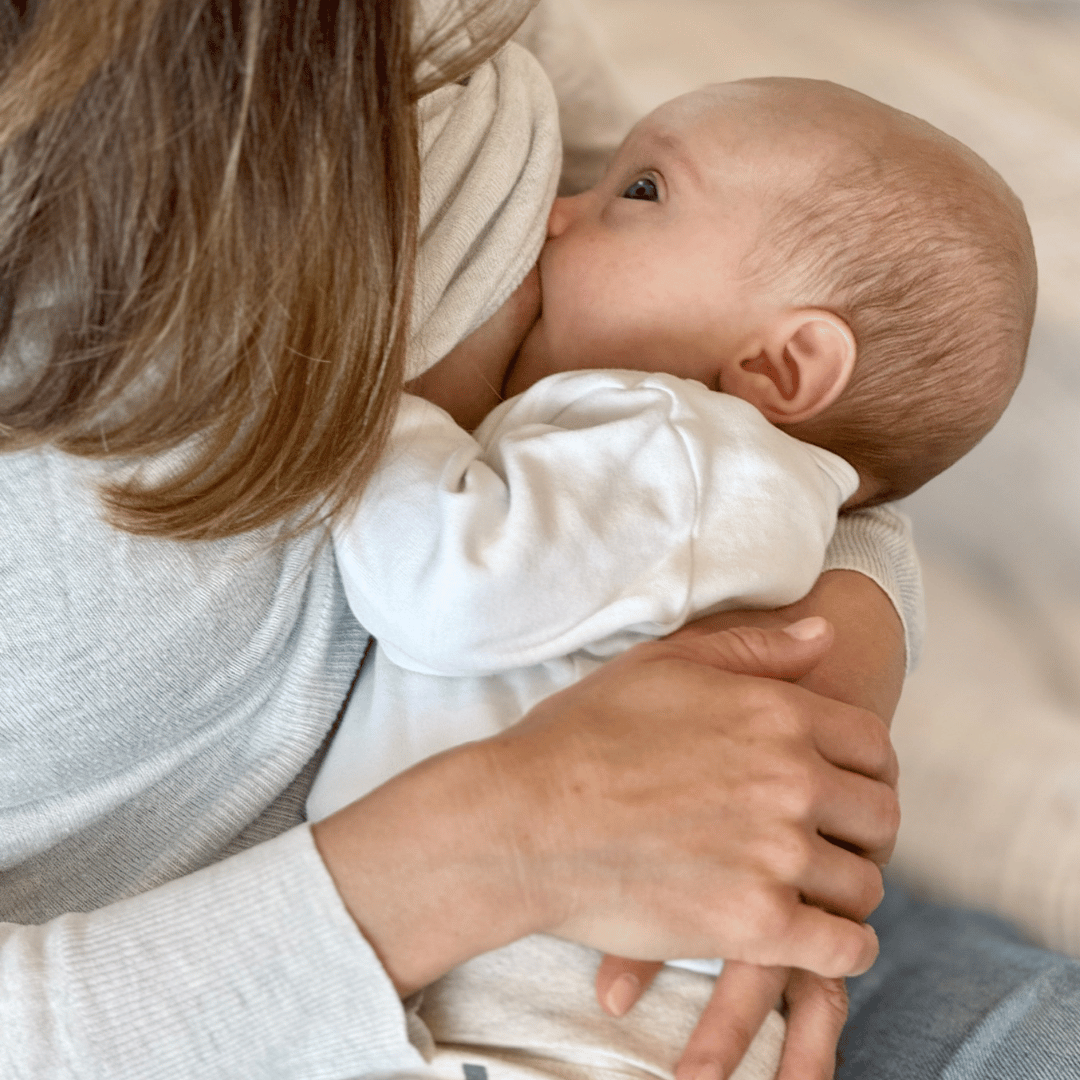 Image of a woman breastfeeding her newborn