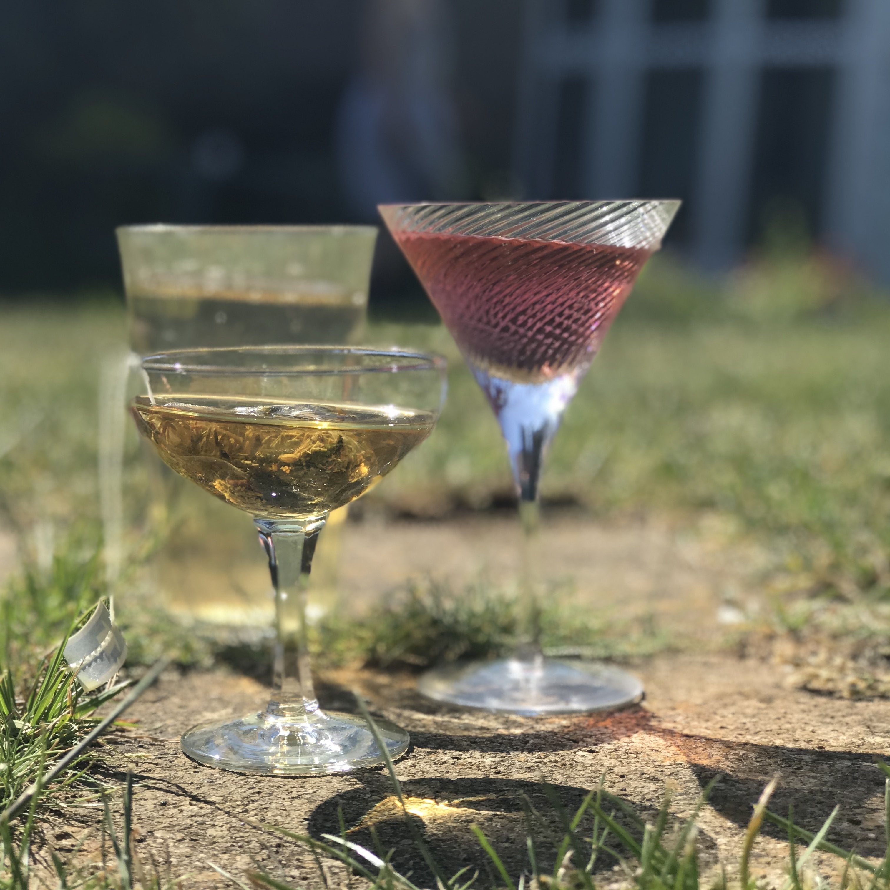 3 glasses filled with mocktails in a sunny garden