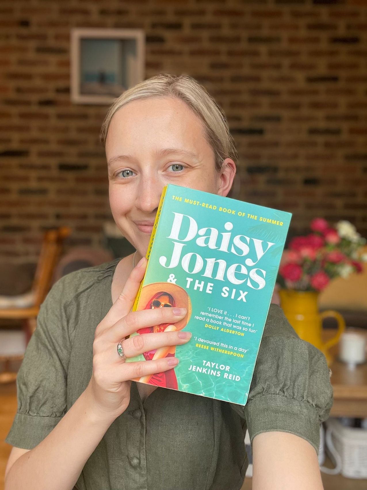 Woman holding 'Daisy Jones and the Six' book