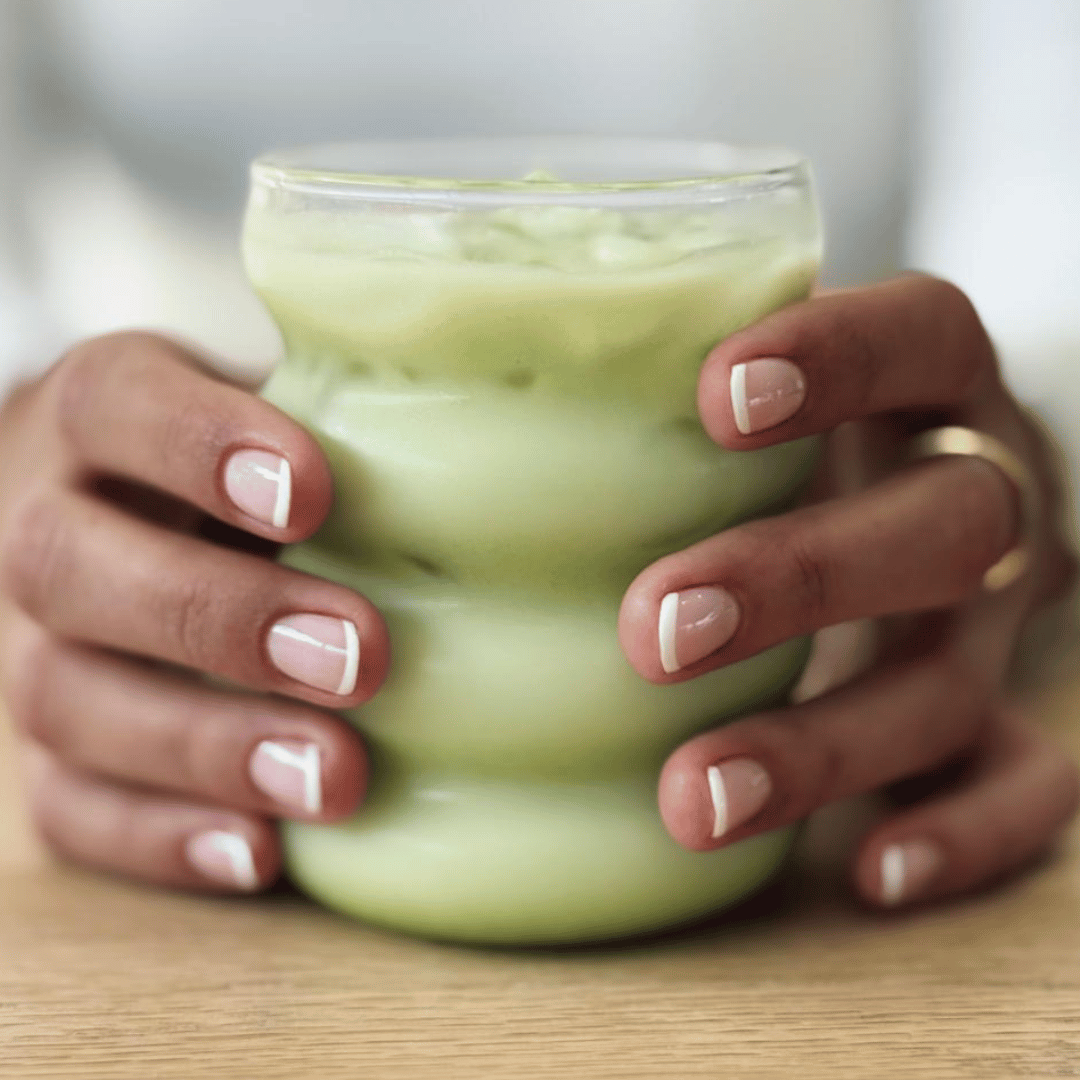 Image of a cup of matcha being held in two hands