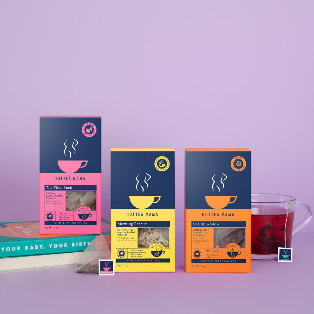 HotTea Mama Pregnancy Tea Collection with The Final Push raspberry leaf tea on a book called your baby, your birth, with Morning Rescue morning sickness tea and Get Up and Glow fruit tea which is pregnancy safe