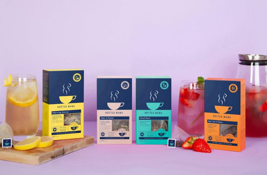 Range of 4 HotTea Mama herbal teas brewed in iced tea jug and glases on lilac background