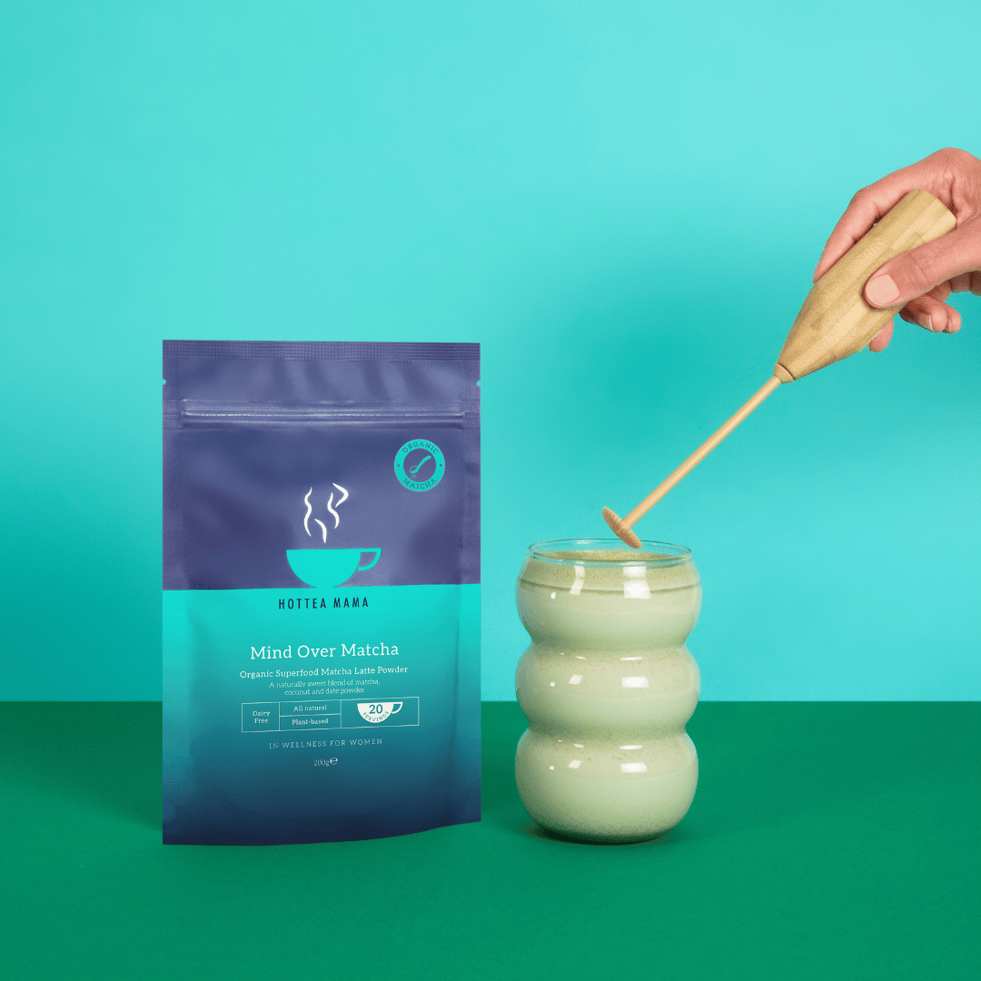 HotTea Mama Mind Over Matcha packaging with a glass of matcha and a hand stirring it against a teal background